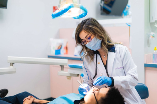 Dr. Christianne Lee performing routine dental work on a patient